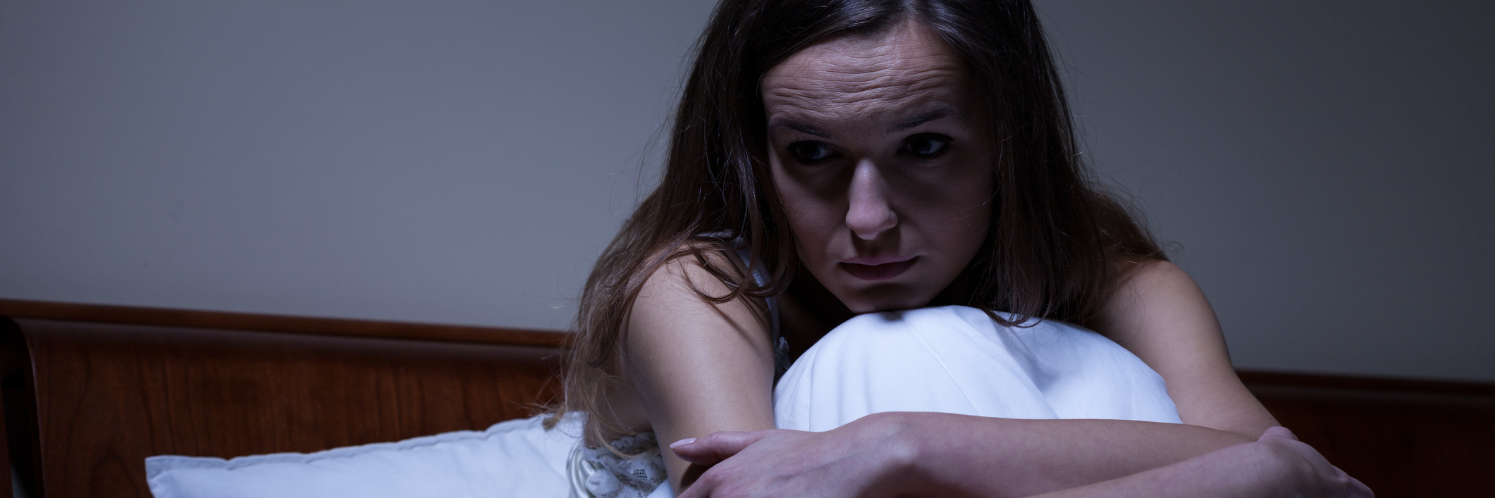 woman sitting in bed at night