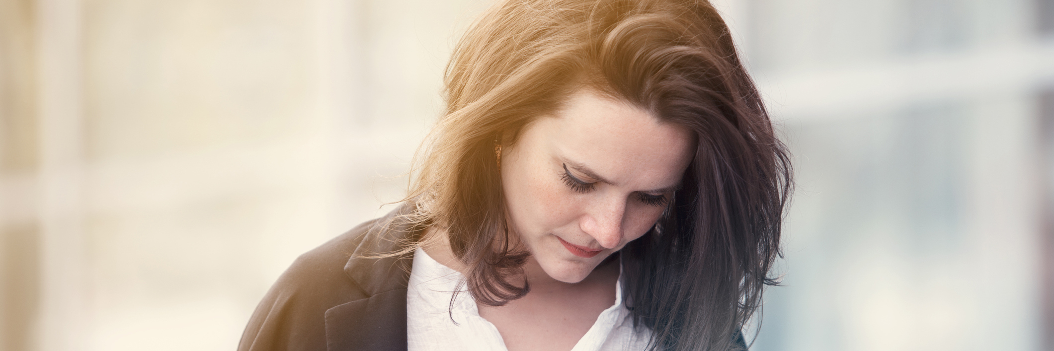 Woman looking at ground anxiously.