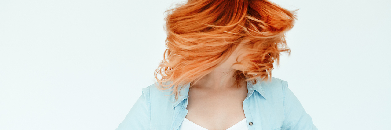 How to Explain What a Panic Attack Feels Like to Friends A woman tossing her hair