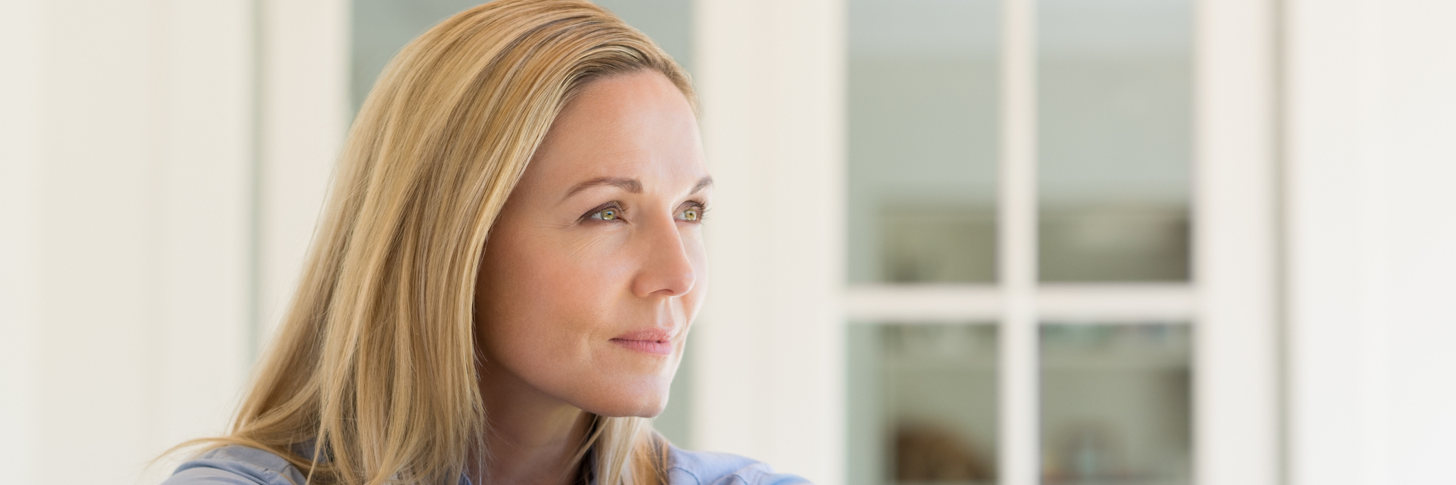 How Gaining Knowledge About Neurofibromatosis Has Empowered Me woman sitting by window thinking