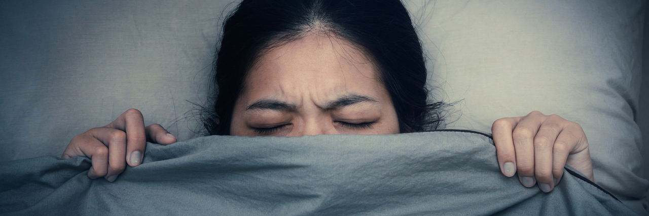 When Self-Care Turns to Self-Sabotage A woman under the covers