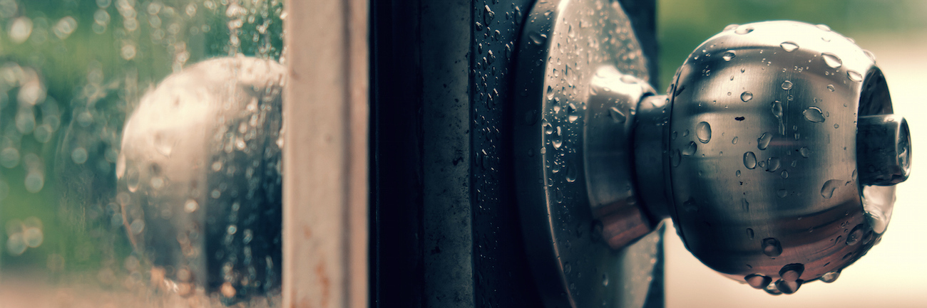 Coping With Feelings of Grief After the Loss of My Son Rain drops on door handle and glass window on rainy day