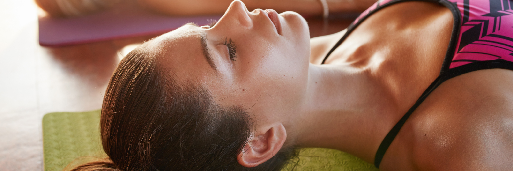 woman lying on their mats practicing yoga