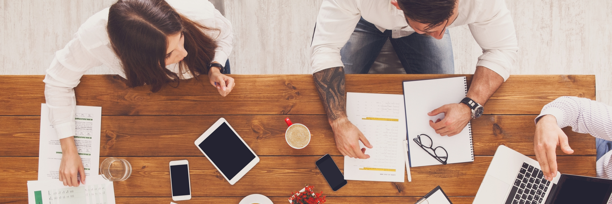 group of businesspeople working at a table in their office