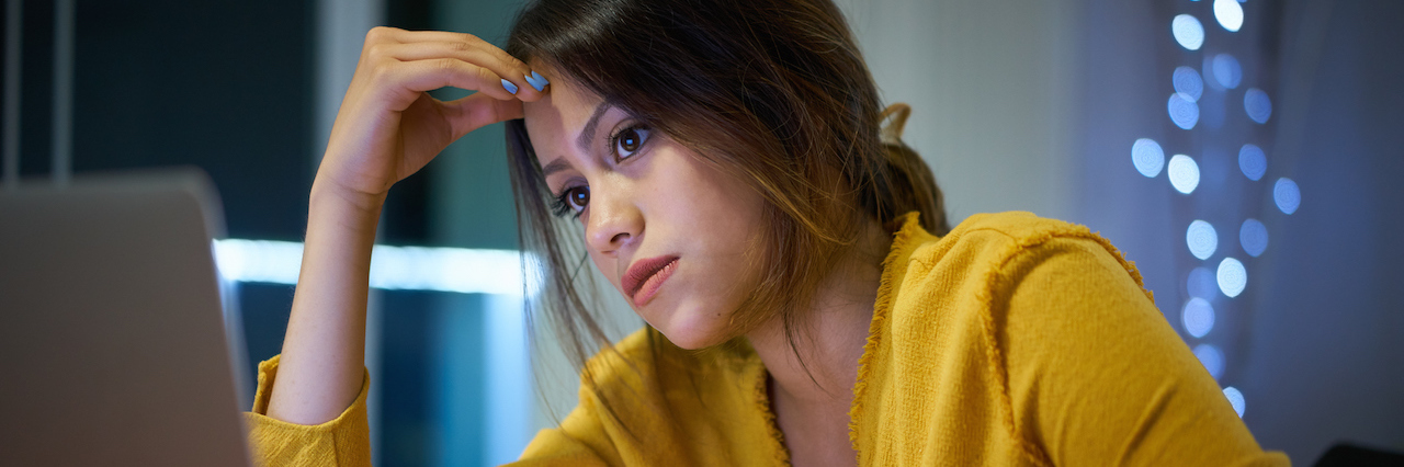 Anxiety: the Cost of Being the 'Perfect' Student A woman looking stressed at her laptop