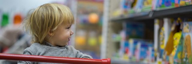 young boy in shopping cart
