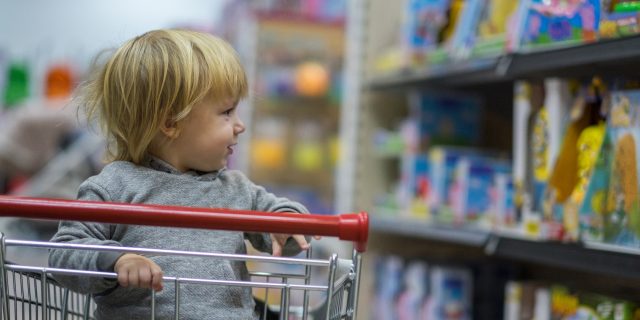 young boy in shopping cart