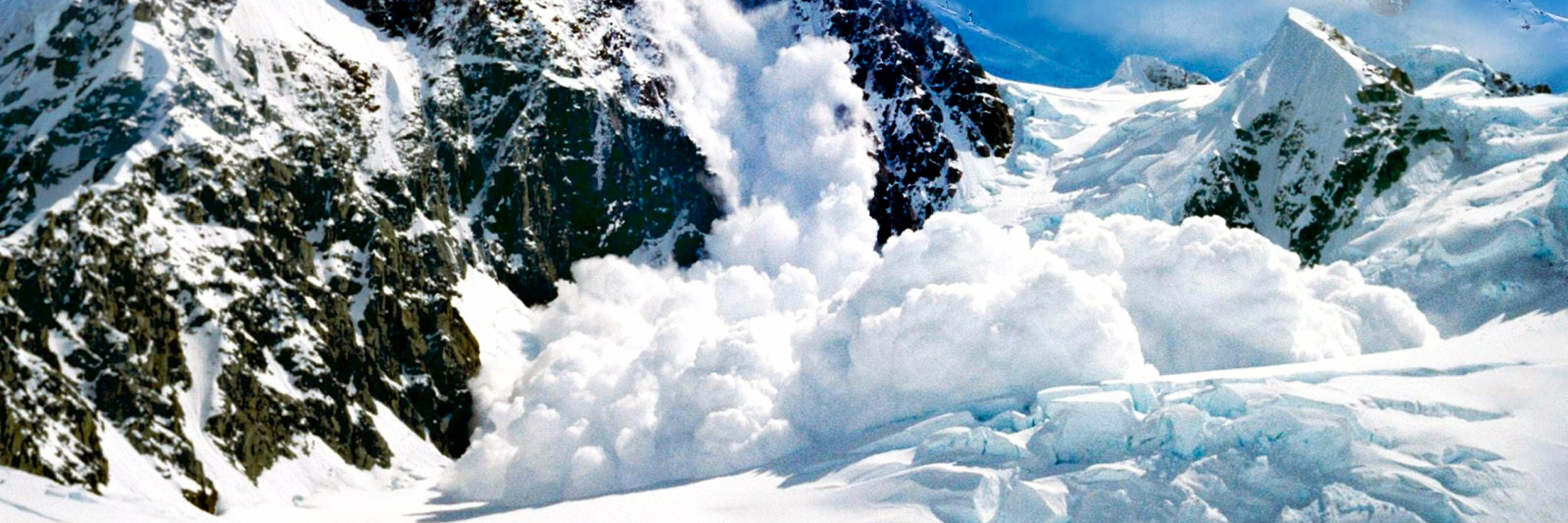 avalanche rolling off snowy mountains in Canada