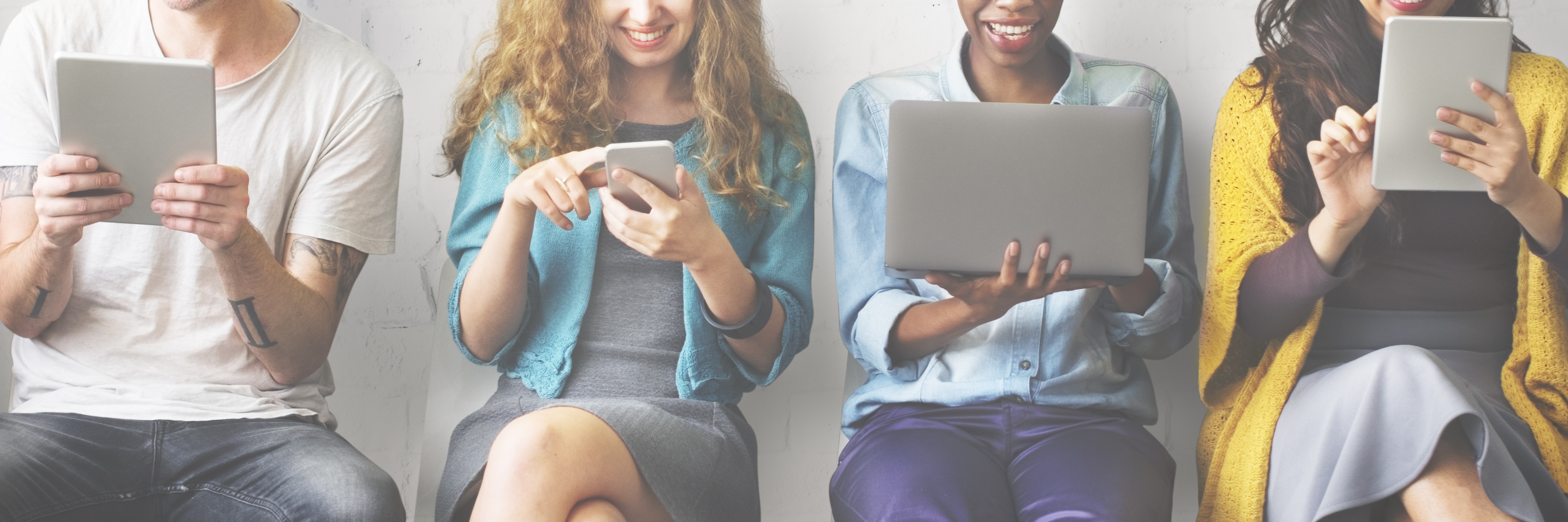 The Problem With Those Viral 'Good Deed' Disability Stories People looking at mobile devices.