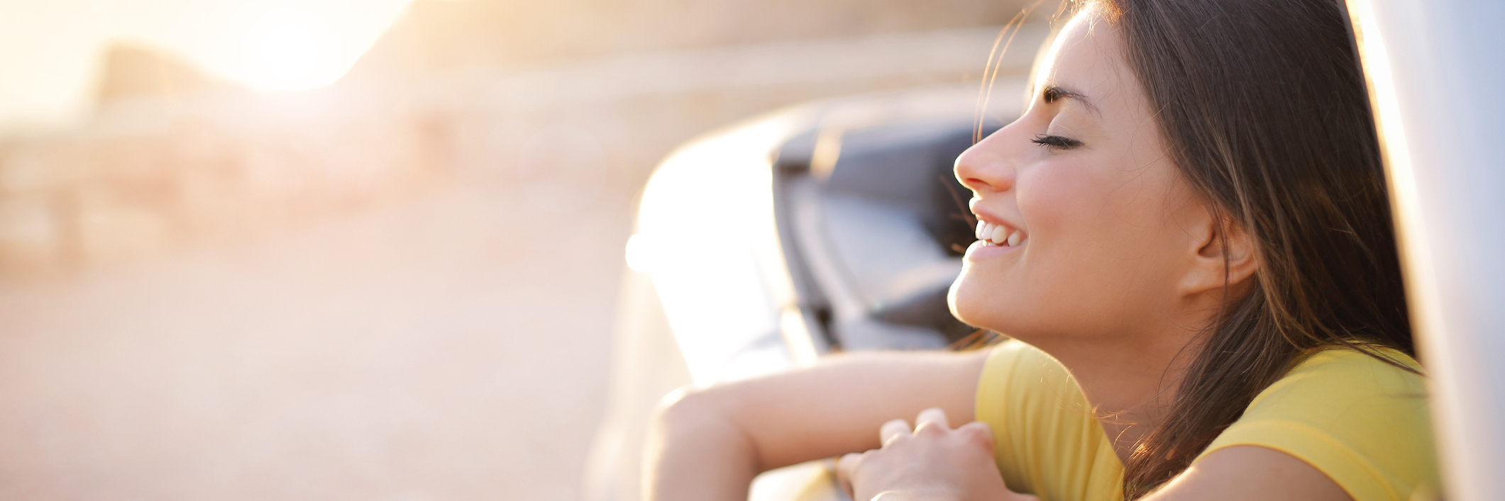 Primary Immunodeficiency: Focusing on Future Plans Instead of Health woman leaning out car window smiling and enjoy the air