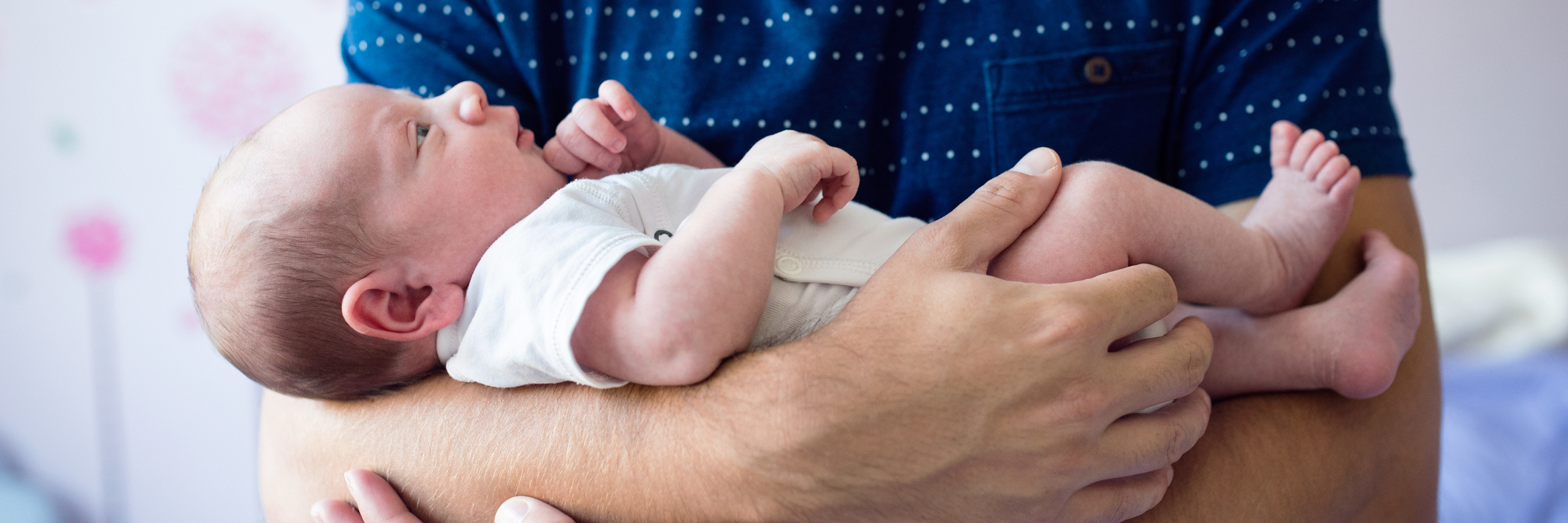 How It Feels to Be a Dad Struggling With Depression Close up of unrecognizable young father holding his newborn baby son in his arms