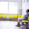 woman sitting in a waiting room at a doctor's office