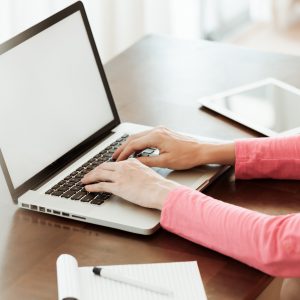 woman typing on her computer
