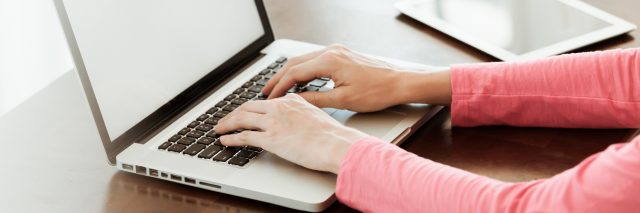 woman typing on her computer