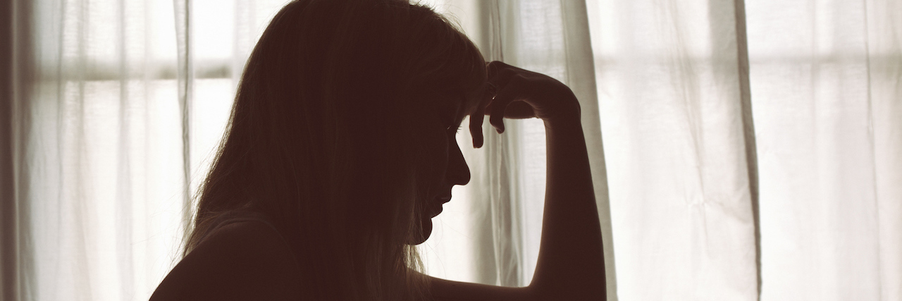 How You Can Help Me Get Through My Summertime Depression Silhouette of woman sitting in bed by window