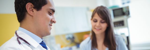 male doctor talking to female patient
