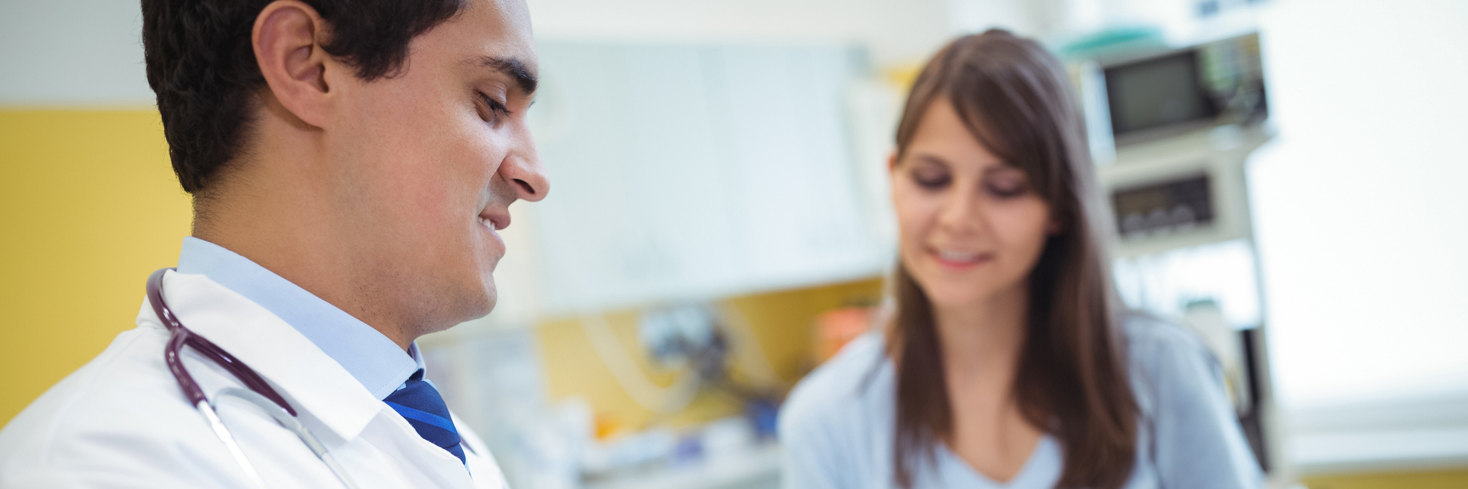 When Doctors Don't Validate Chronic Pain, Say It's 'All in Your Head' doctor talking with patient and writing on his tablet