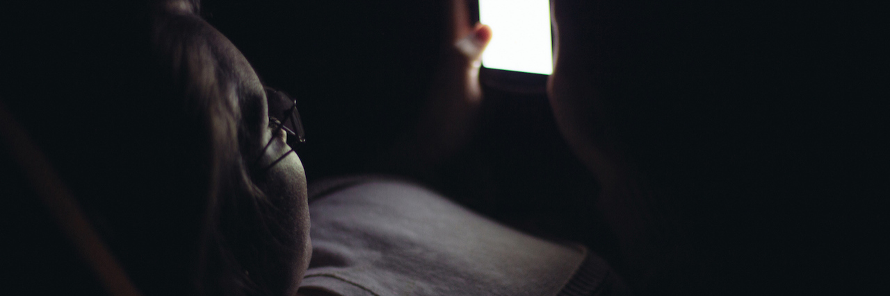 Advice to Those Afraid to Admit They're Struggling With Anxiety Woman looking at her phone at night