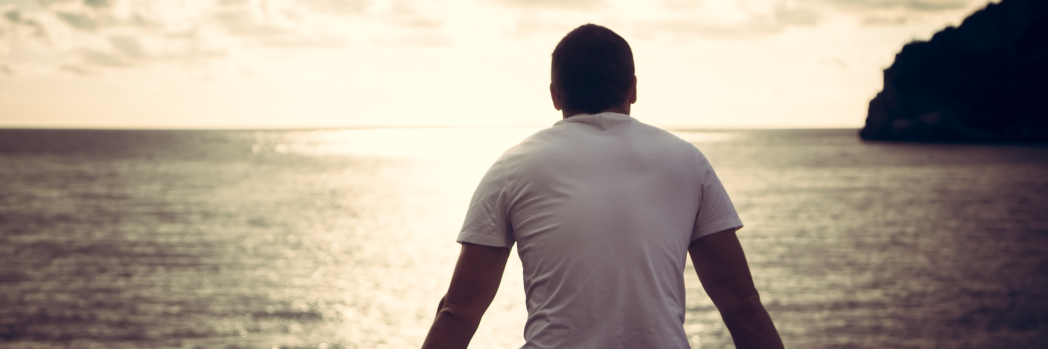 Why I Don't Care About What Caused My Follicular Lymphoma man sitting by water looking at sunset