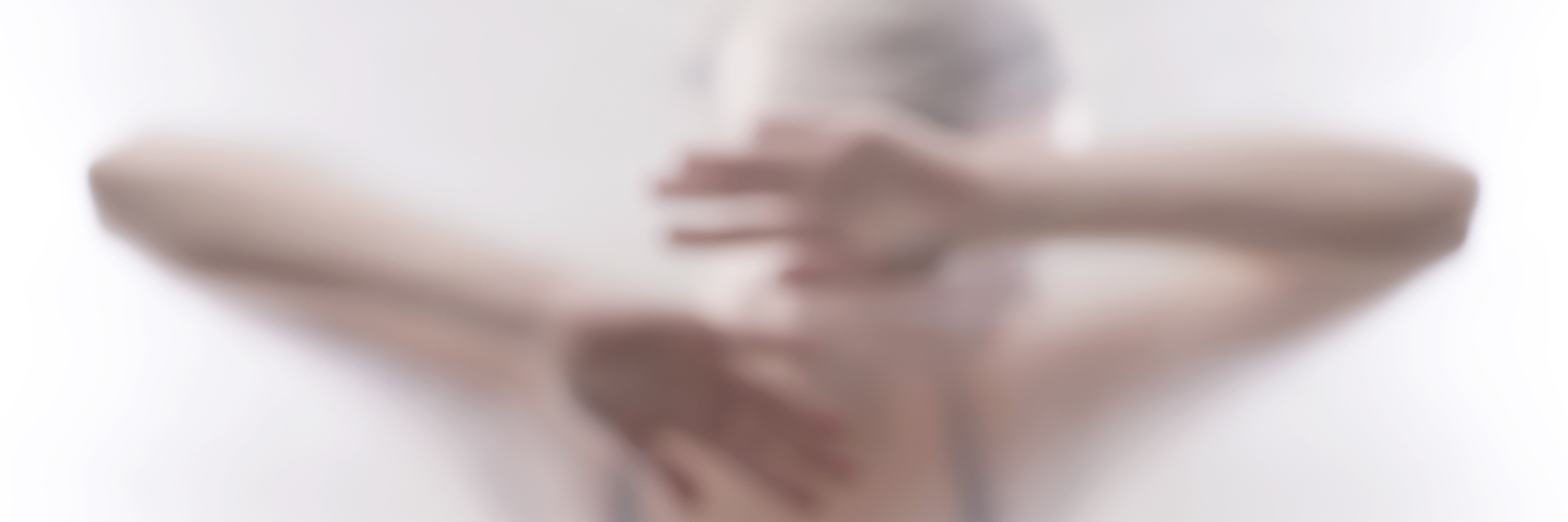 Fibromyalgia Isn't All of Who I Am A young woman behind a clear curtain with a blurred affect overlay.