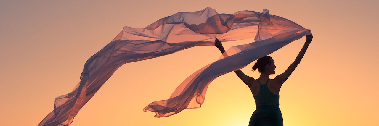 Thank You to The Therapist Who Gave Me Hope A woman holding a silk cloth in the wind