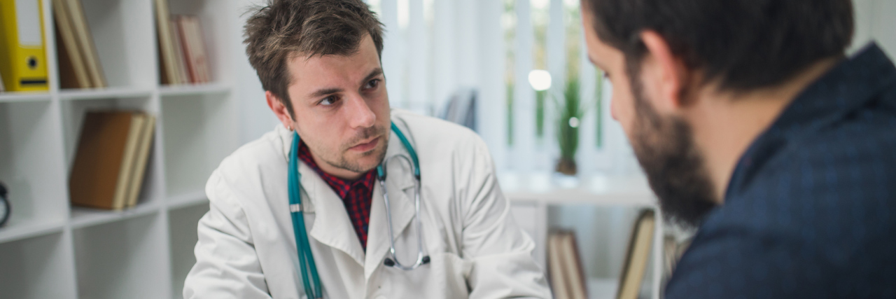 Doctors Only Taking Chronic Back Pain Seriously After Surgery man talking with his doctor