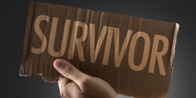 hand holding survivor sign