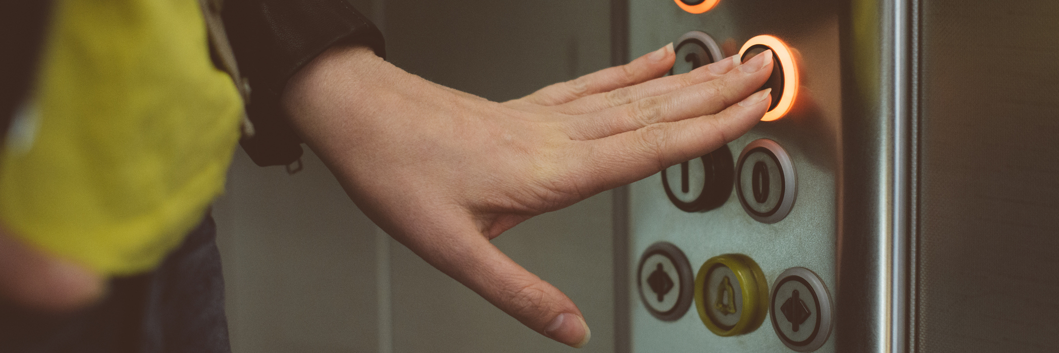 Ehlers-Danlos Syndrome: Being Judged for Using the Elevator woman pressing buttons in an elevator