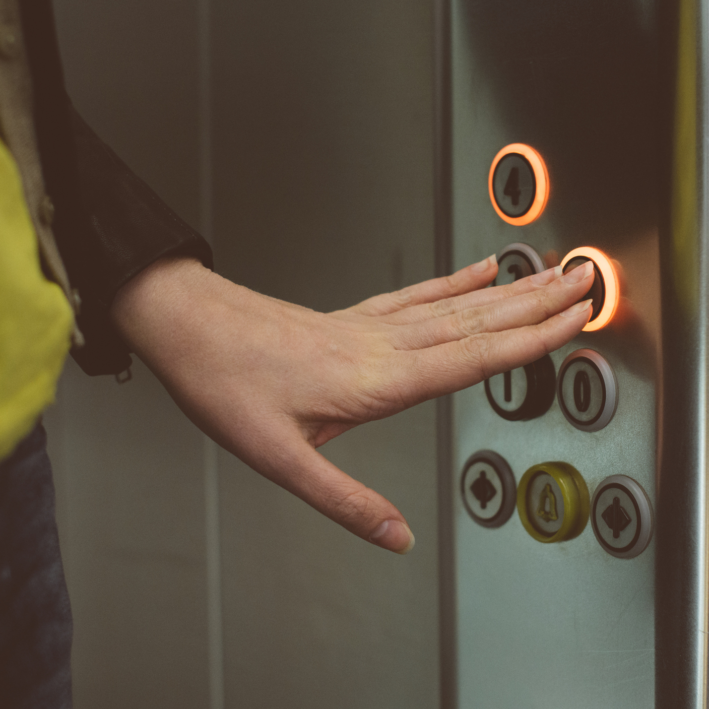 woman pressing buttons in an elevator