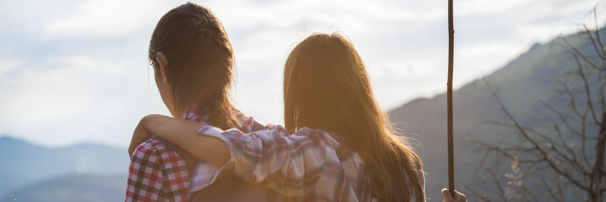 Finding Acceptance After Hearing Loss Two friends hiking. One wears a hearing aid.