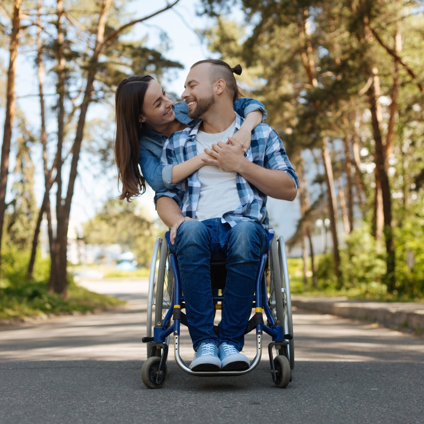Happy couple, the man uses a wheelchair.