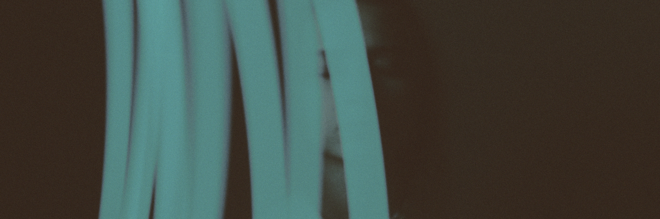 What It's Like Living With Chiari Malformation Young woman standing behind a blur of blue lights.