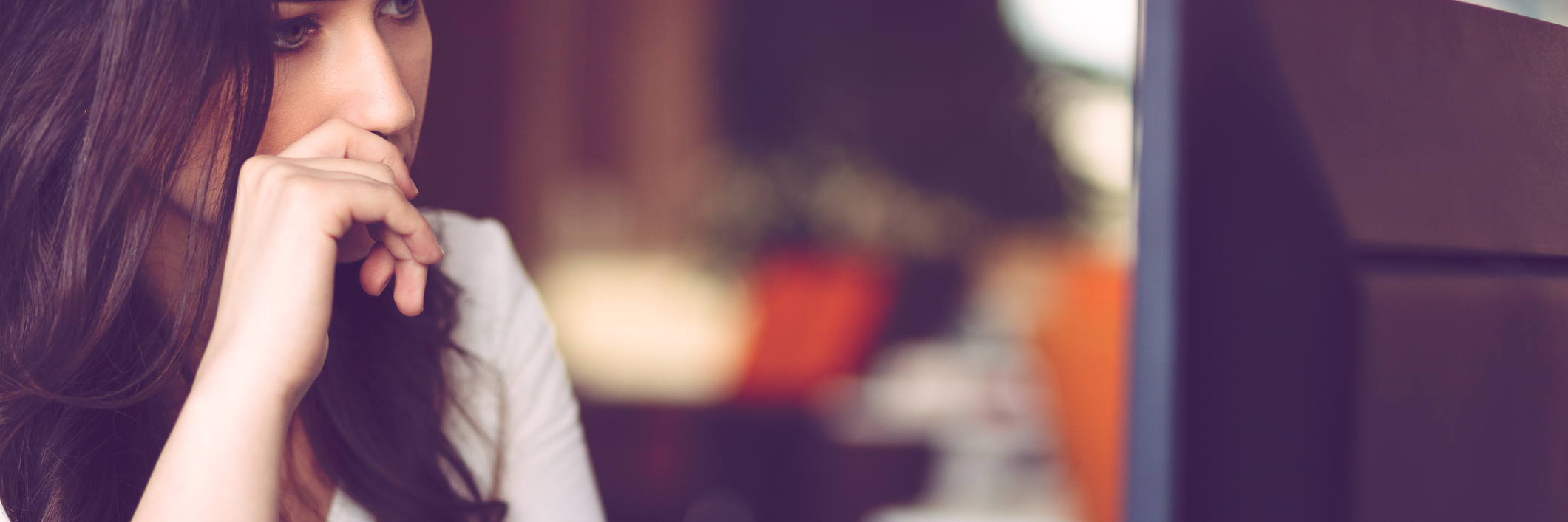 Why I Struggle to Explain My New Anxiety Diagnosis young woman looking anxious in front of computer wearing white shirt