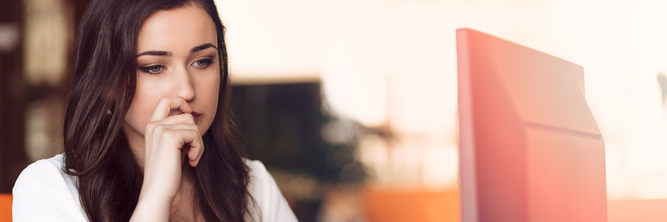 Why My Anxiety Means I Can't Just 'Calm Down' woman sitting at computer looking anxious or worried