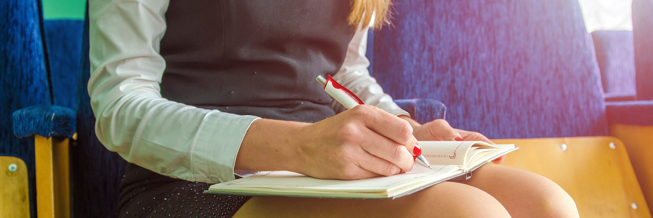 A Letter About Overcoming OCD woman writing in her notebook