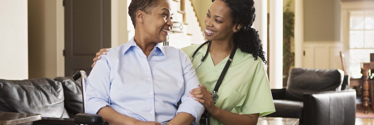 The Importance of Personal Care Attendants Personal care attendant with woman in wheelchair at home.