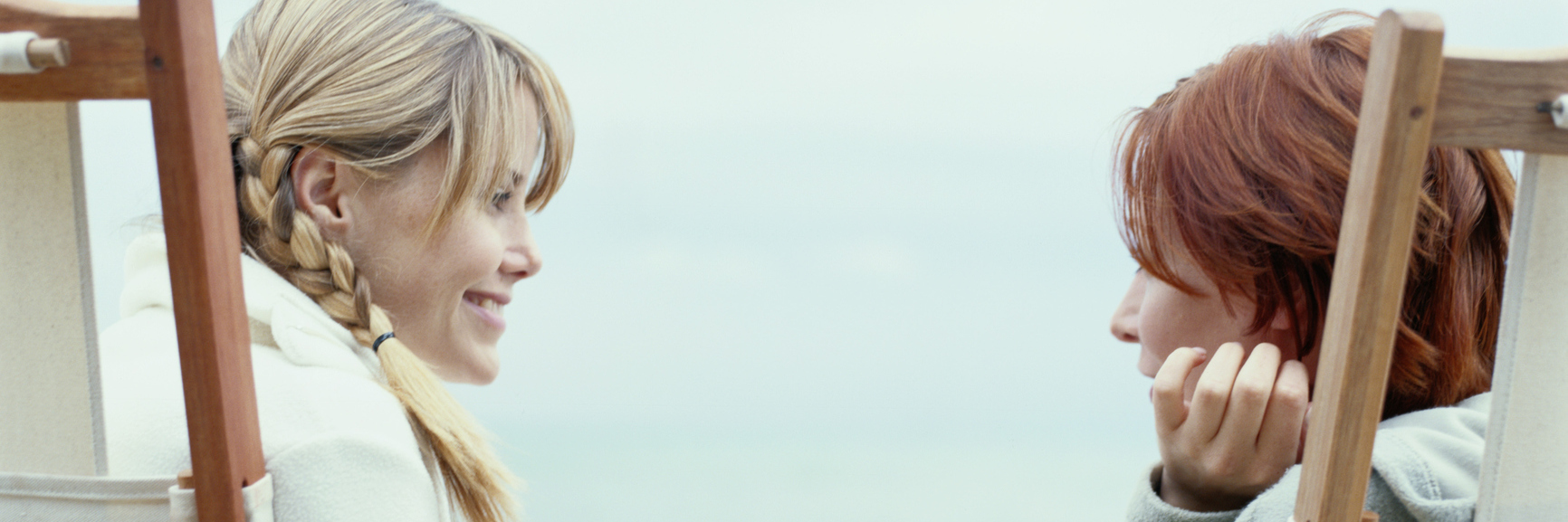 What Not to Say to Someone With Chronic or Mental Illness, Disability two women sitting in chairs on the beach and talking