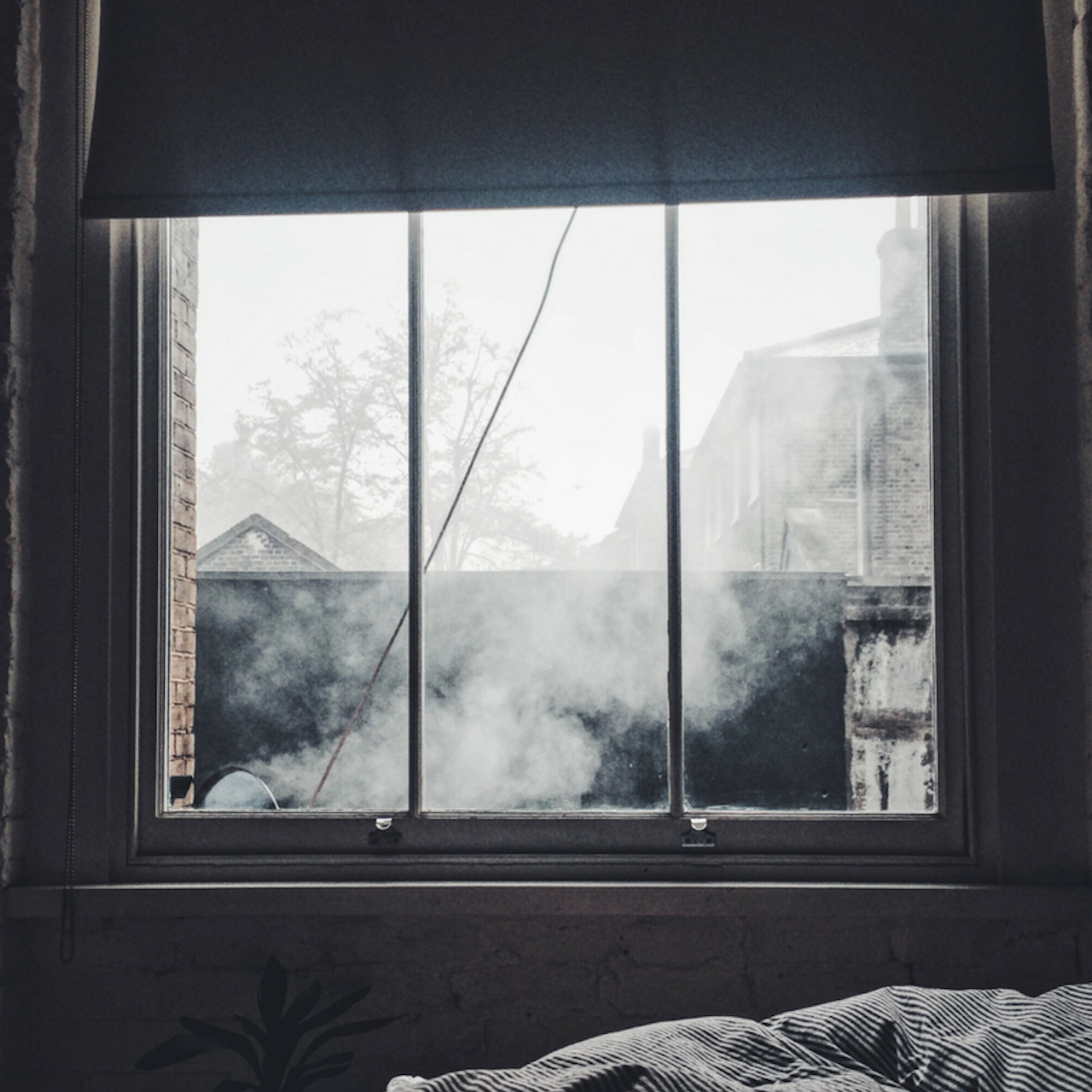 photo of window looking out on dark sky and smoke