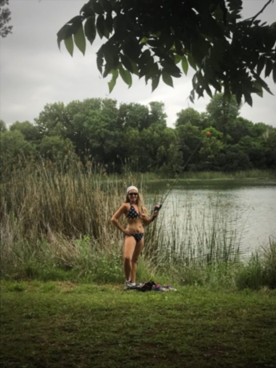 Photo of a woman by a lake wearing a bikini