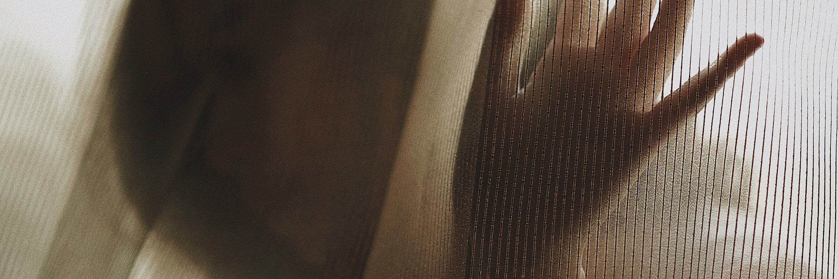 When Depression Makes Me Numb, Not Sad woman obscured by curtains mostly in shadow