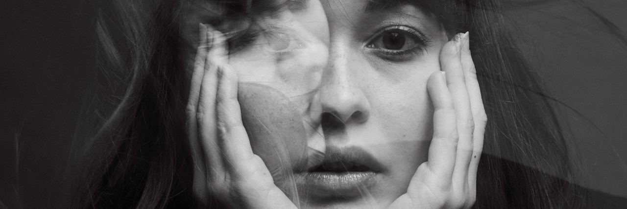 black and white photo of woman resting chin on hands and looking into camera with double exposure
