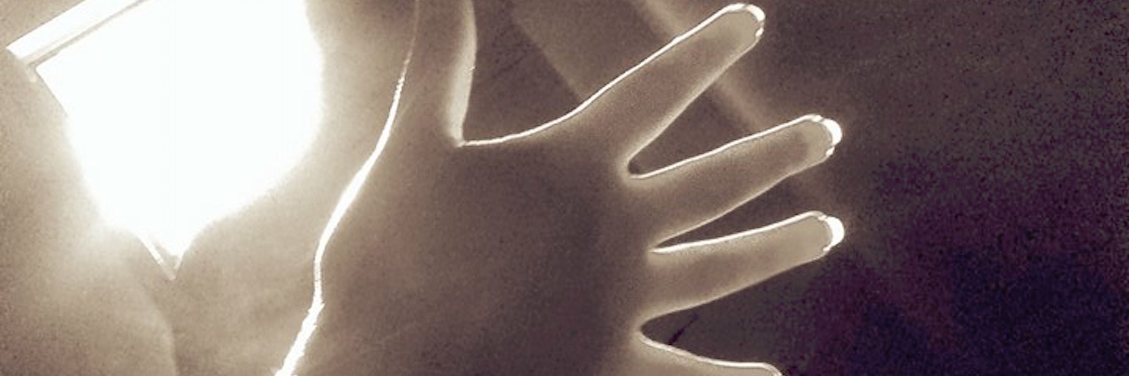 When Death by Suicide Leaves You Asking ‘Why?’ hand reaching toward light