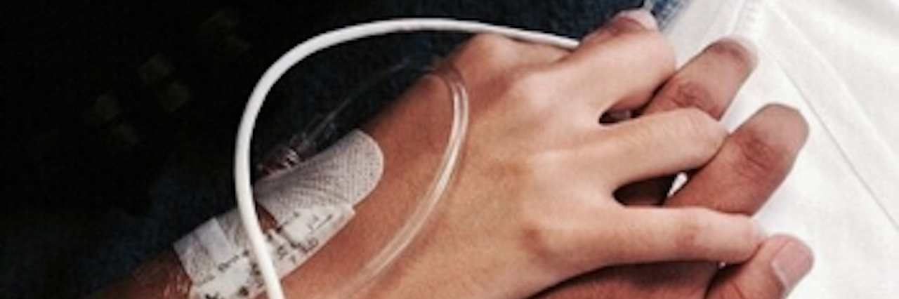 Letter to Future Husband From a Woman With Chronic Illness woman's hand with an IV holding a man's hand