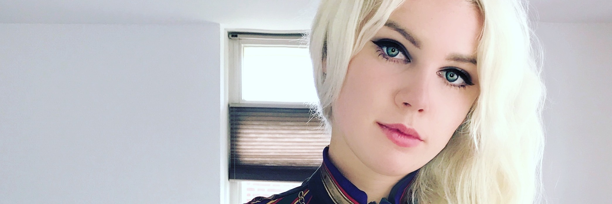 How Perfecting My Appearance Became a Way Of Coping With My Illness A professional photo of the writer standing in a white room.