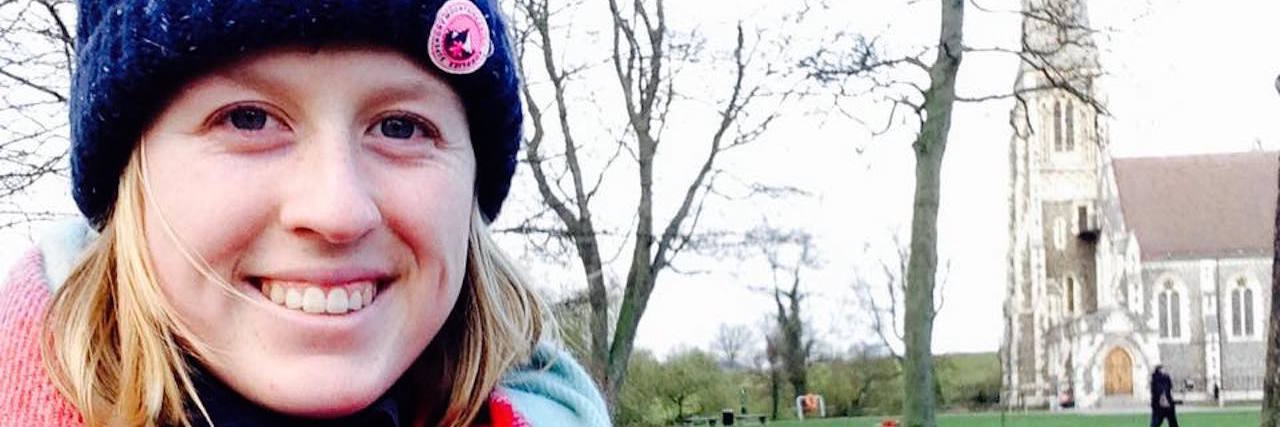 You Might Not Know I’m Struggling With Mental Illness girl smiling looking at the camera wearing a hat and a scarf