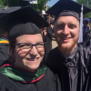professor and student smiling at graduation