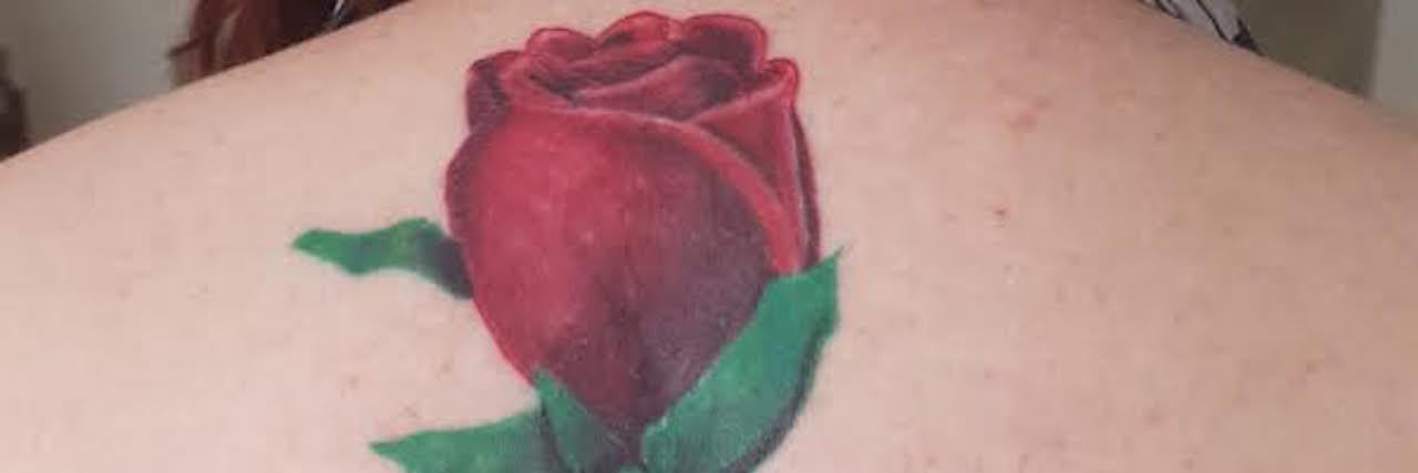 Covering a Scar on My Spine With a Tattoo of a Rose tattoo of a rose on a woman's spine