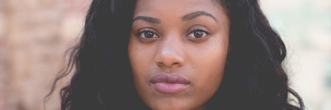 The 3 Steps I Took to 'Bounce Back' After My Suicide Attempt black woman in front of brick wall
