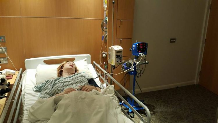 woman lying in hospital bed asleep