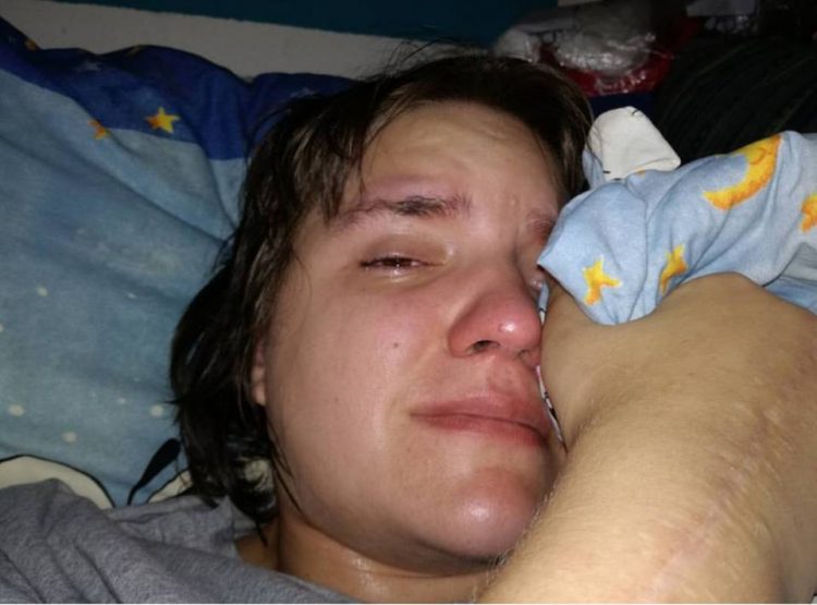 woman lying in bed crying
